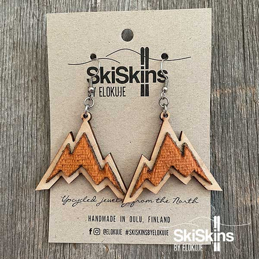 SkiSkins-korvikset, oranssi vuoristo puutaustalla